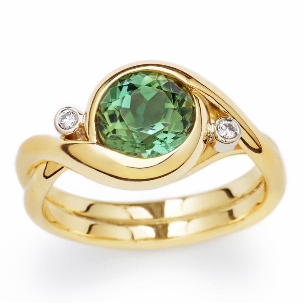 DropboxDONE.Ring_Embrace_GrTourmaline_gold_FS_Finished-Done Embrace - Yellow gold with a green tourmaline and two accent diamonds.